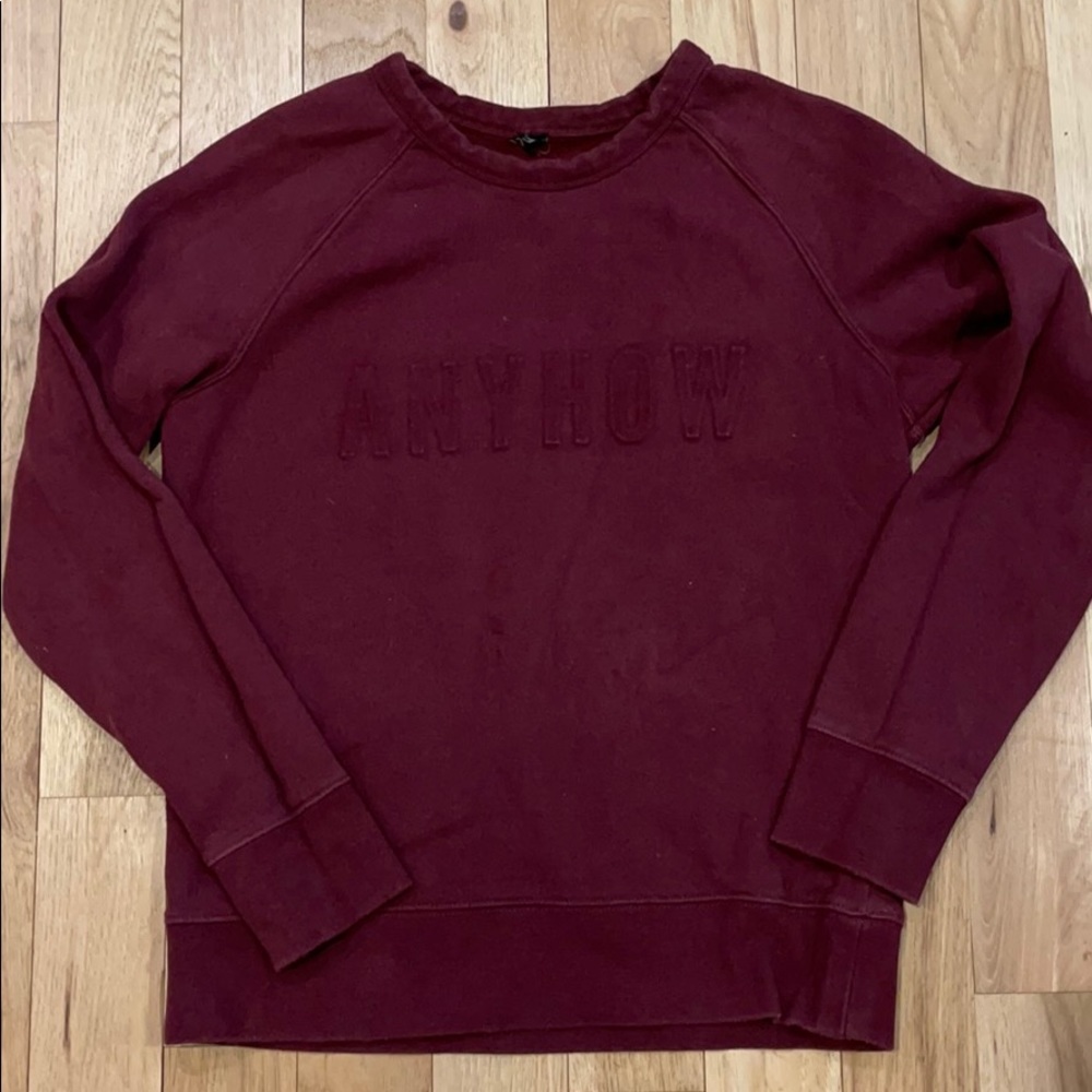 Embossed maroon sweatshirt saying “anyhow”